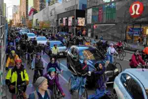 Large group of cyclists occupying multiple downtown Toronto traffic lanes during a public cycling demonstration.
