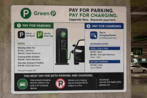 Toronto Green P sign showing separate fees for EV charging and parking in municipal parking garage