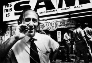 Black-and-white photo of Sam Sniderman outside Sam the Record Man on Yonge Street in Toronto in 1971.